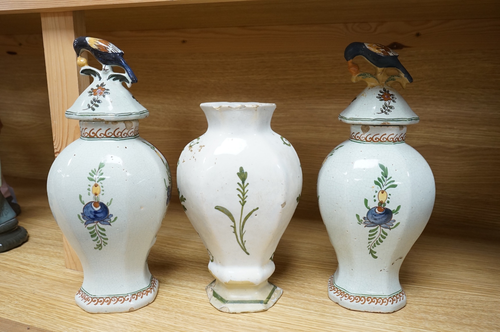 Three 18th/19th century Delft vases, the pair decorated with portraits of king and queen, H 30cm x W 15 (with lids), H 23cm x W 15 (without lid)